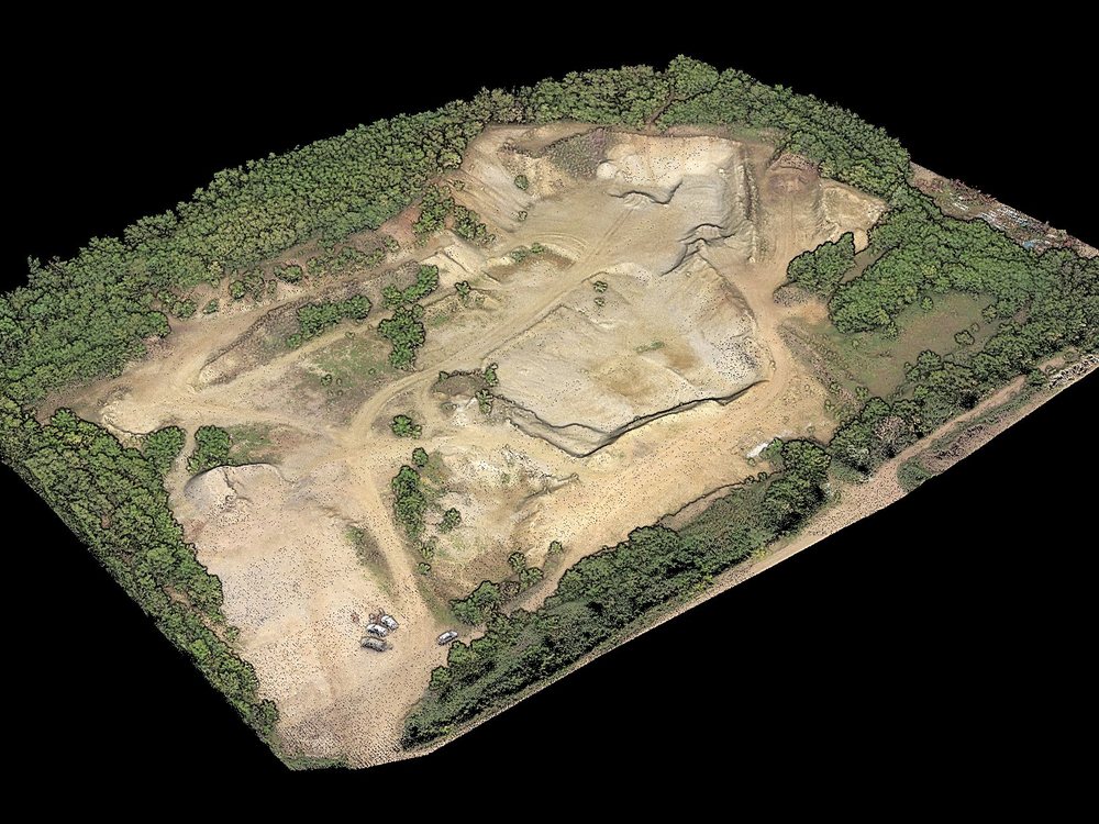Lidaretto H32X point cloud of an open-pit mine with haul roads, surrounded by forest